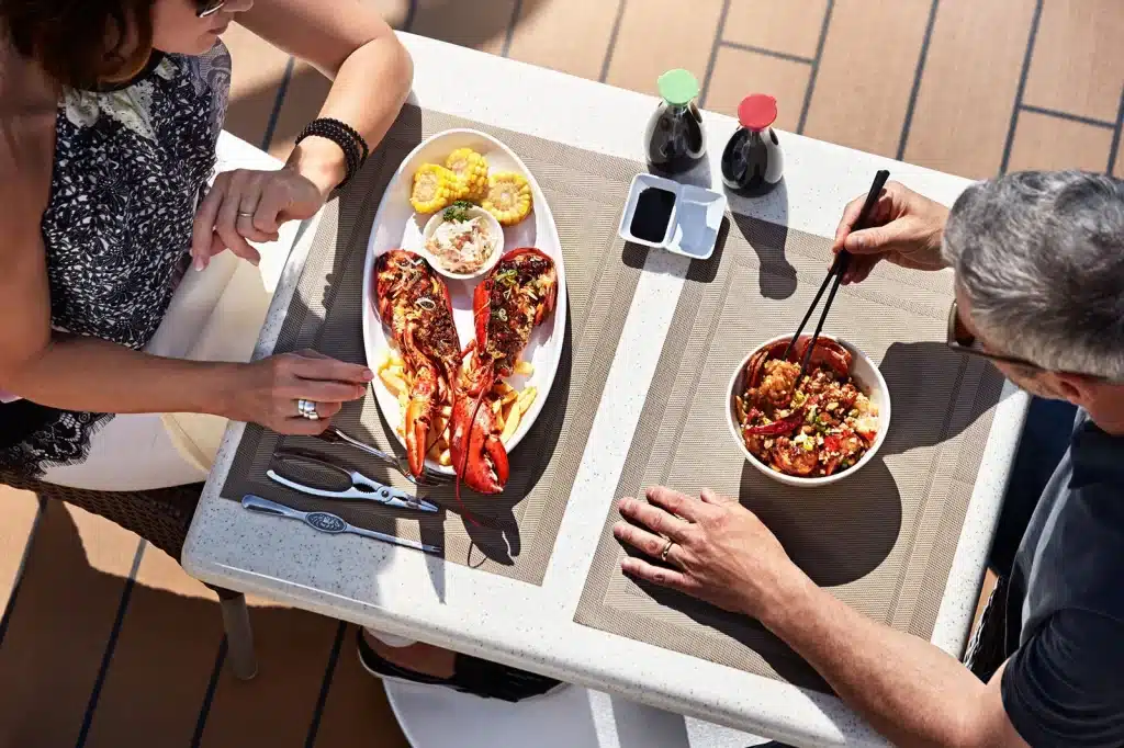 A top view of people enjoying food at a cruise line deck