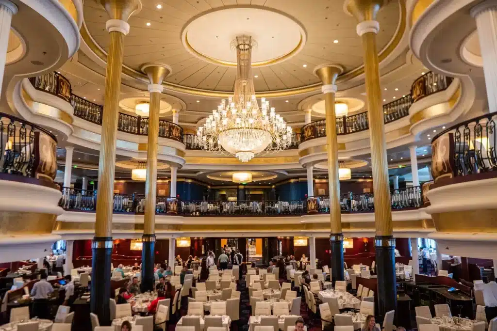 A wide view of a royal dining hall inside a cruise ship