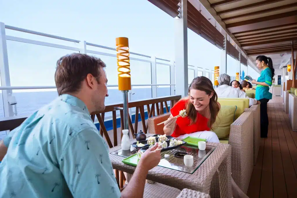 People enjoying outdoor food setting at a cruise ship