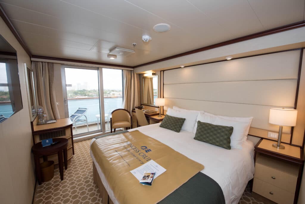 balcony cabins on a cruise with cozy bed side tables and lamps