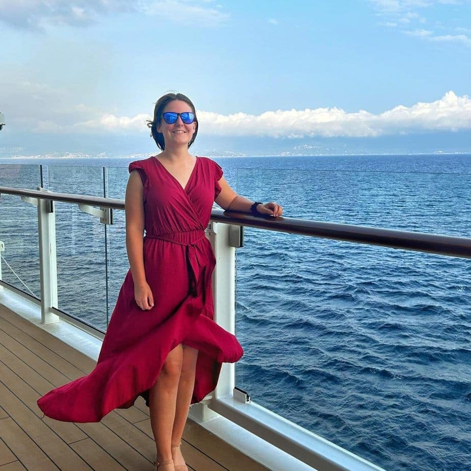 girl wearing cocktail dress standing on a cruise