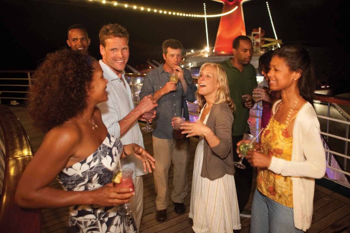 group of people enjoying on a cruise holding drinks