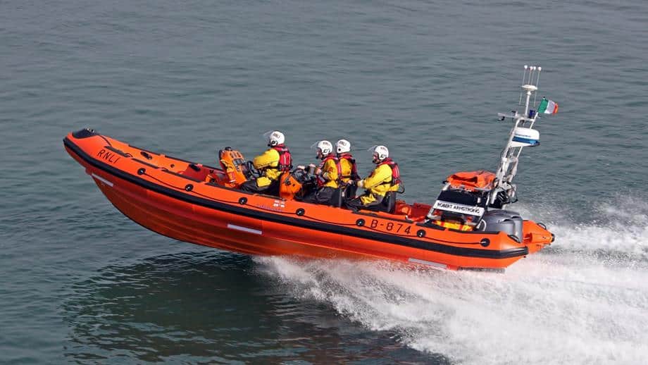 orange lifeboat with passengers