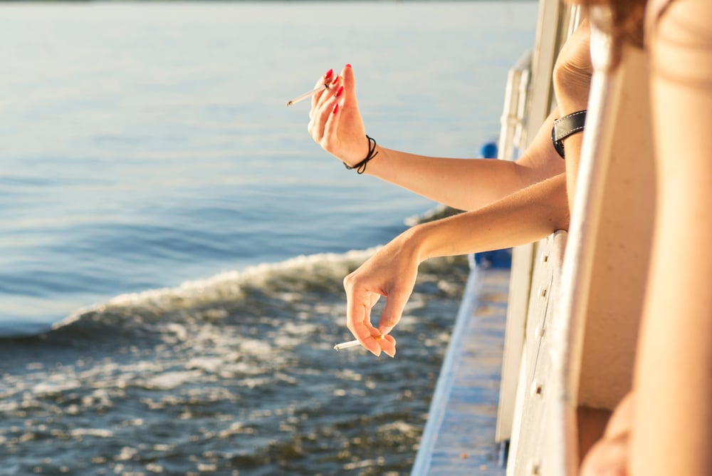 Two Women Smoke Cigarettes On Board The Drift Hands Of