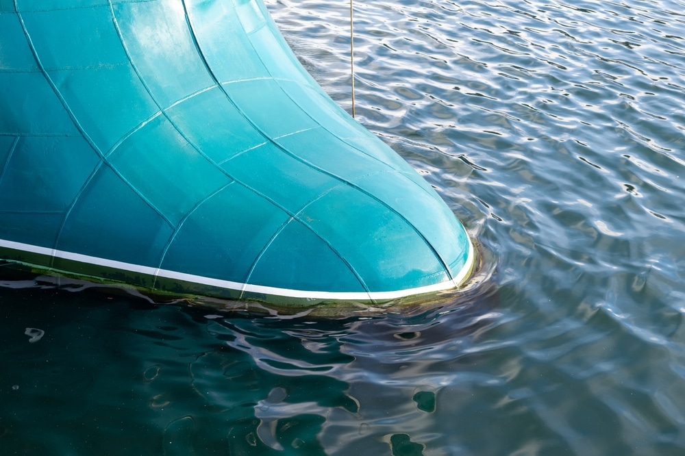 The Bulbous Bow Of A Blue Boat With A Cream