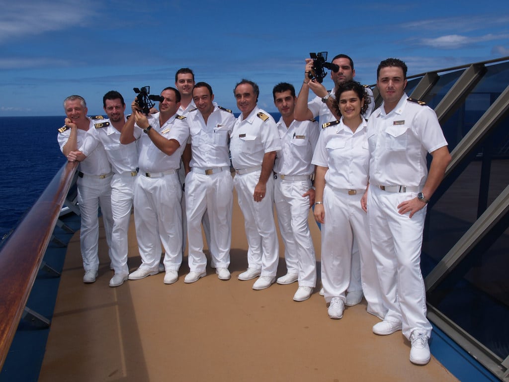 carnival cruise crew standing on cruise ship