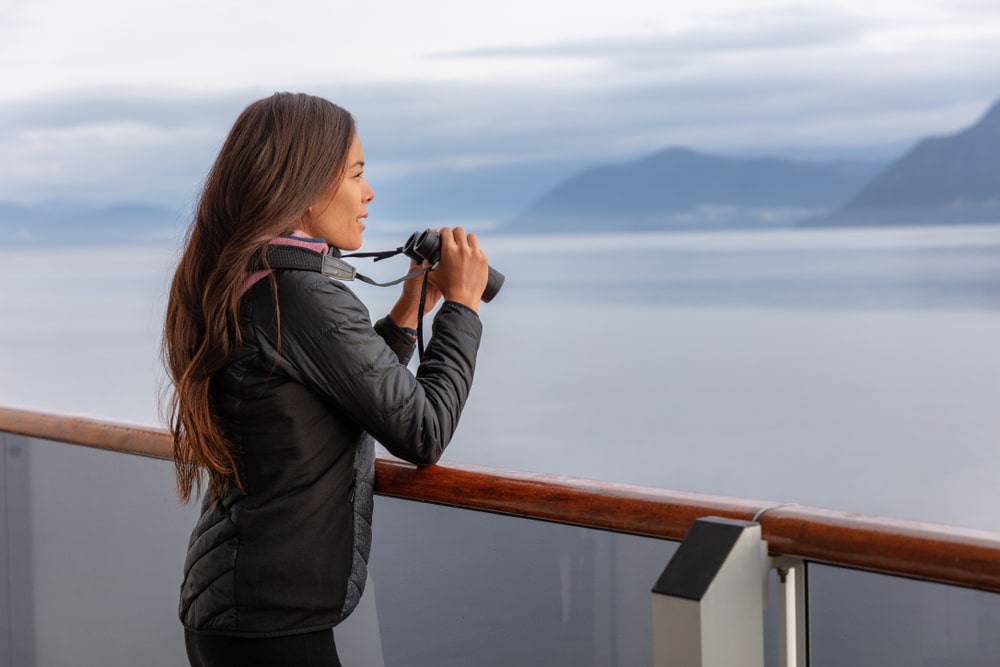 Alaska Cruise Woman On Whale Watching Boat Excursion Tour Looking